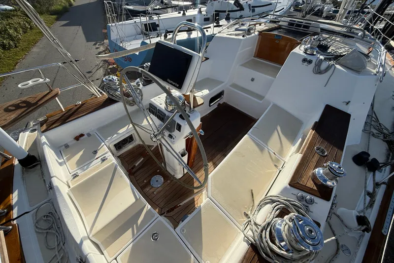 Slide: The Image of Cockpit of 2011 Tartan 4700 sailboat with steering wheel and navigation equipment. - 24