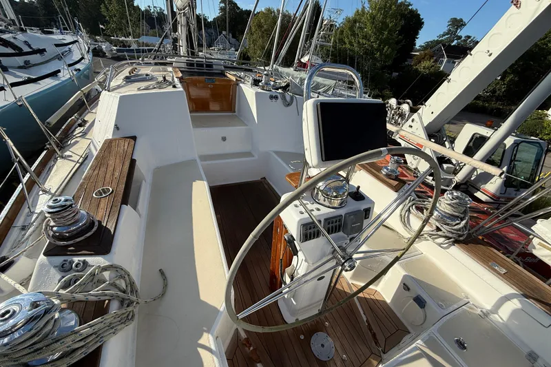 Slide: The Image of Cockpit of 2011 Tartan 4700 sailboat with steering wheel and navigation equipment. - 26
