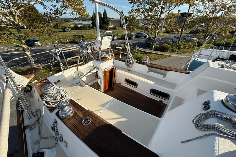 Slide: The Image of Sailboat cockpit of 2011 Tartan 4700 with wooden accents and steering wheel. - 27