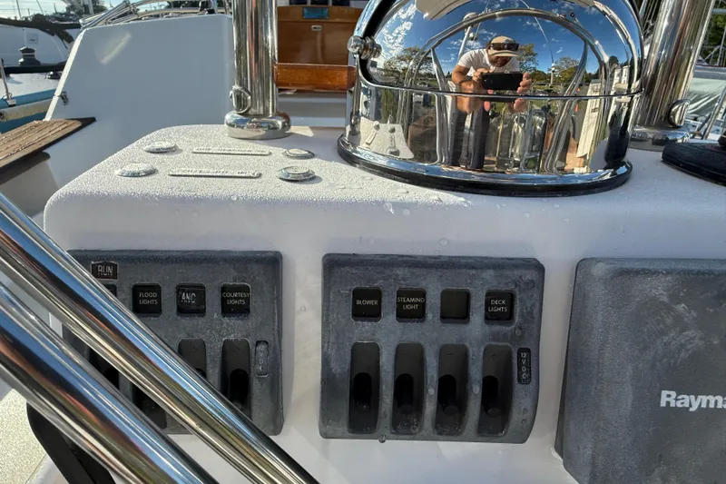 Slide: The Image of Control panel on a 2011 Tartan 4700 yacht with switches and reflective surfaces. - 29