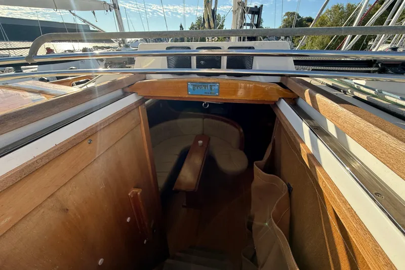 Slide: The Image of Interior view of a 2011 Tartan 4700 sailboat, showcasing wooden cabin entrance. - 34