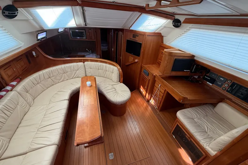 Slide: The Image of Luxurious interior of a 2011 Tartan 4700 yacht with elegant wood finishes and plush seating. - 35