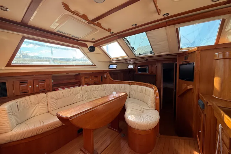 Slide: The Image of Luxurious interior of 2011 Tartan 4700 yacht with plush seating and wooden finishes. - 36