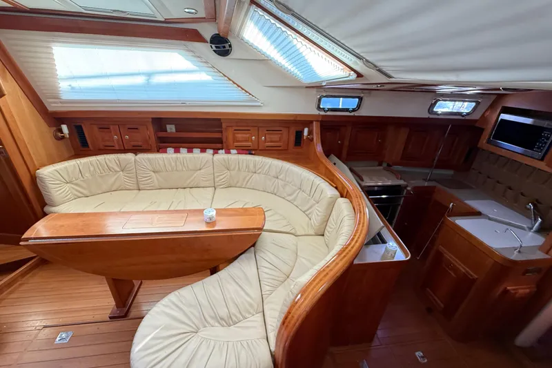 Slide: The Image of Luxurious interior of 2011 Tartan 4700 yacht with curved seating and modern kitchen. - 38