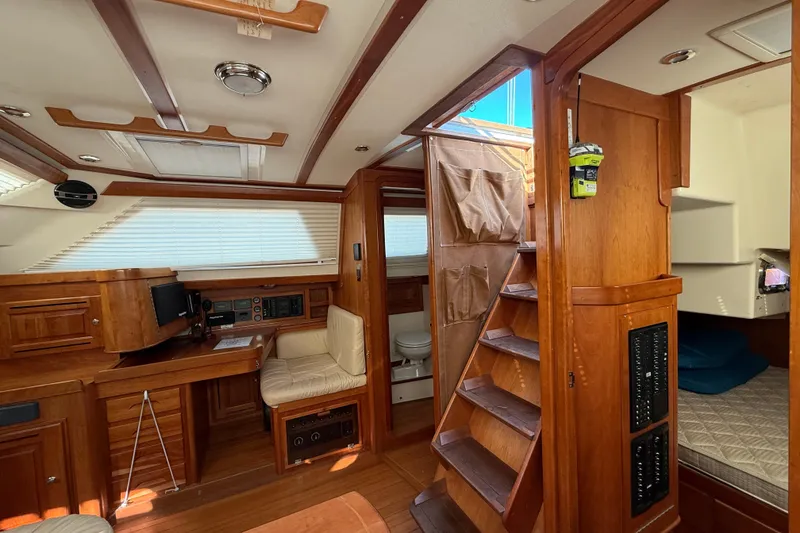 Slide: The Image of Interior of 2011 Tartan 4700 yacht with wooden furnishings and cozy seating area. - 39