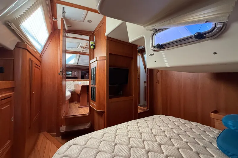Slide: The Image of Luxurious interior of 2011 Tartan 4700 yacht with wood finish and cozy cabin. - 45