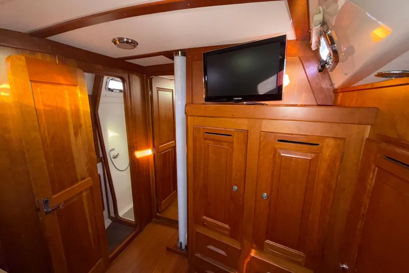 Slide: The Image of Interior of 2011 Tartan 4700 yacht with wooden cabinetry and mounted TV. - 46