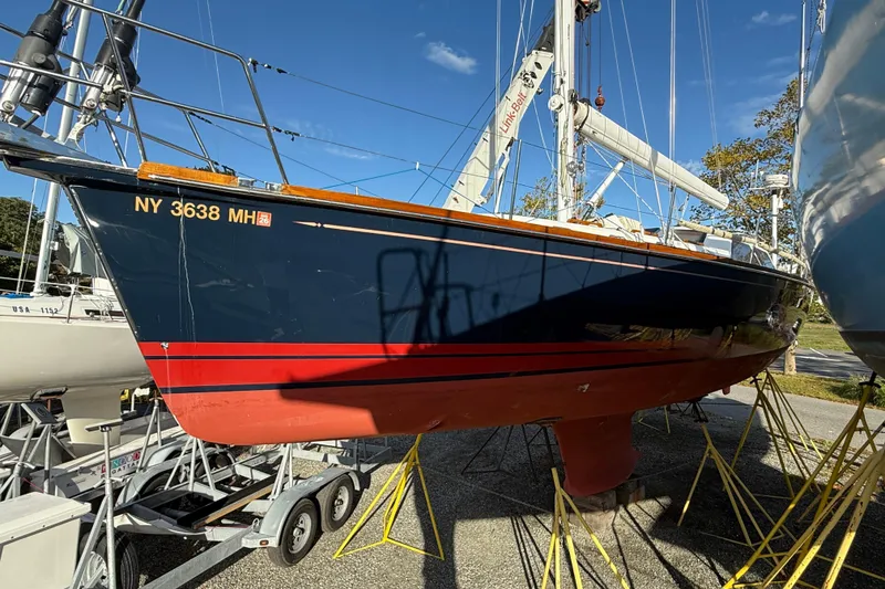 Slide: The Image of Sailboat Tartan 4700, 2011 model, on trailer with blue hull and red stripe. - 5