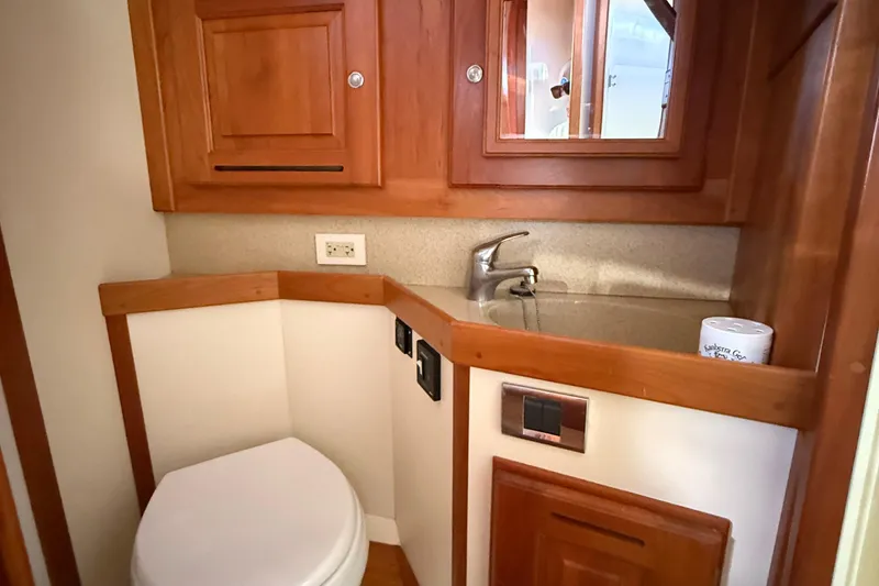 Slide: The Image of Compact bathroom in 2011 Tartan 4700 yacht with wooden cabinetry and modern fixtures. - 53