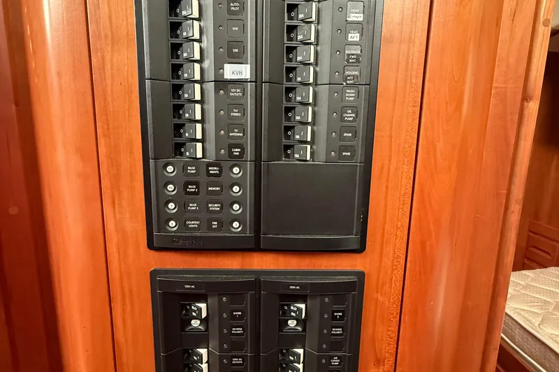 Slide: The Image of Electrical panel on a 2011 Tartan 4700 yacht, featuring switches and controls. - 62
