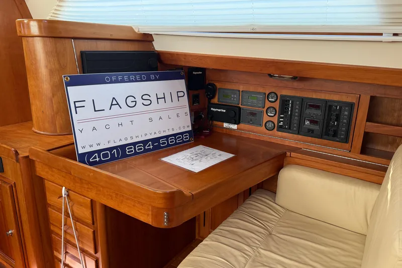 Slide: The Image of Interior of 2011 Tartan 4700 yacht with navigation panel and sales sign. - 67