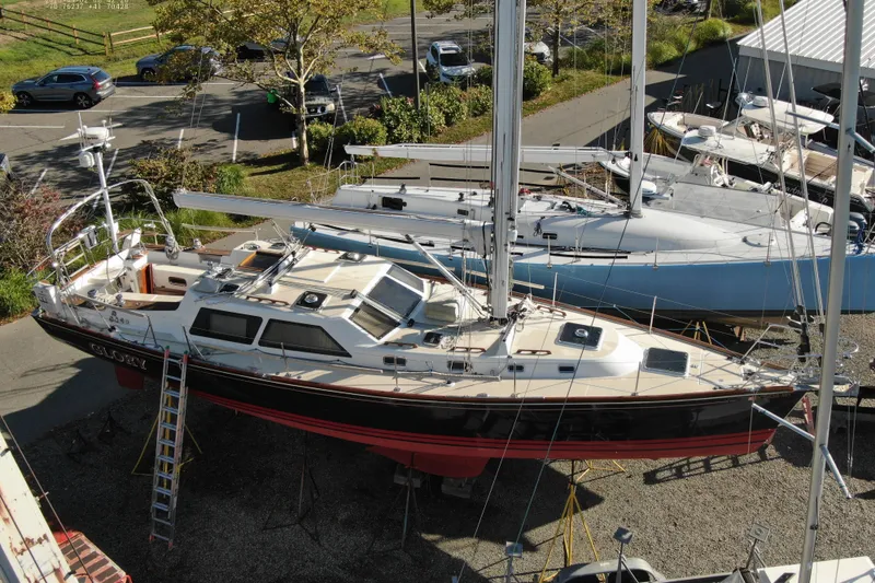 Slide: The Image of Sailboat Tartan 4700, 2011 model, docked on land with surrounding boats. - 7