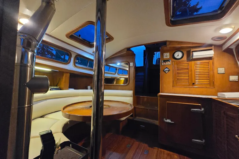 Slide: The Image of Interior of 1981 Cheoy Lee 43 Pilot House with wood finishes and cozy seating area. - 15