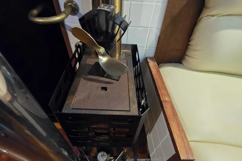 Slide: The Image of 1981 Cheoy Lee 43 Pilot House interior with stove and seating area. - 17