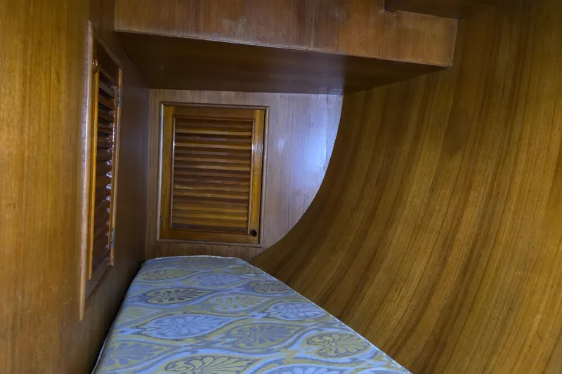Slide: The Image of Interior cabin of 1981 Cheoy Lee 43 Pilot House with wooden paneling and patterned bedding. - 22