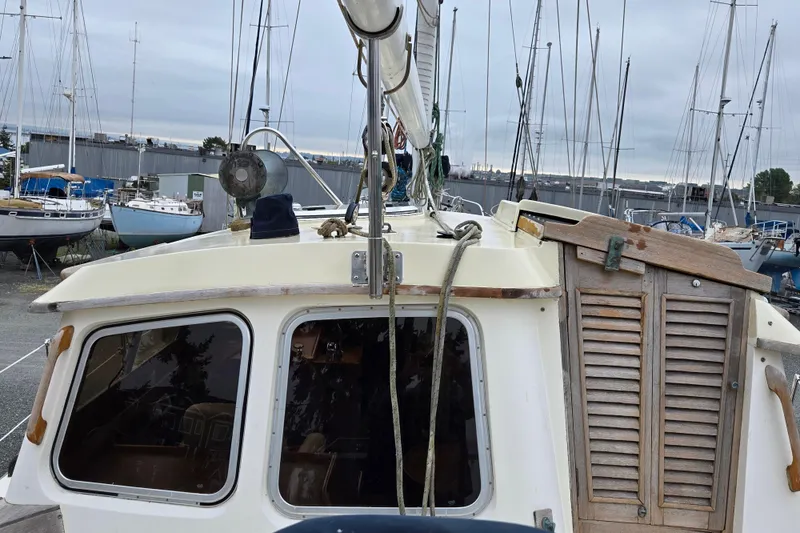 Slide: The Image of 1981 Cheoy Lee 43 Pilot House sailboat in a marina, surrounded by other boats. - 7