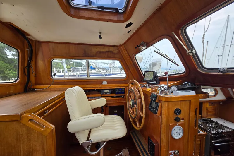 Slide: The Image of 1981 Cheoy Lee 43 Pilot House interior with wooden helm and navigation equipment. - 8
