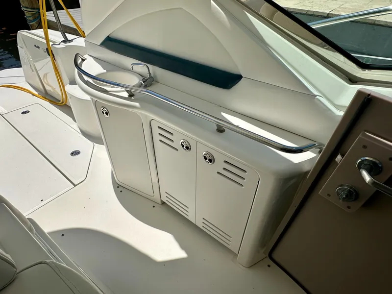Slide: The Image of 2004 Sea Ray 420 Sundancer yacht interior with storage cabinets and railing. - 11