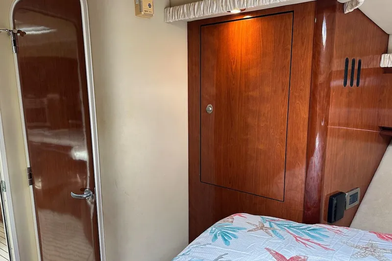 Slide: The Image of Interior of 2004 Sea Ray 420 Sundancer with wooden cabinetry and door. - 18