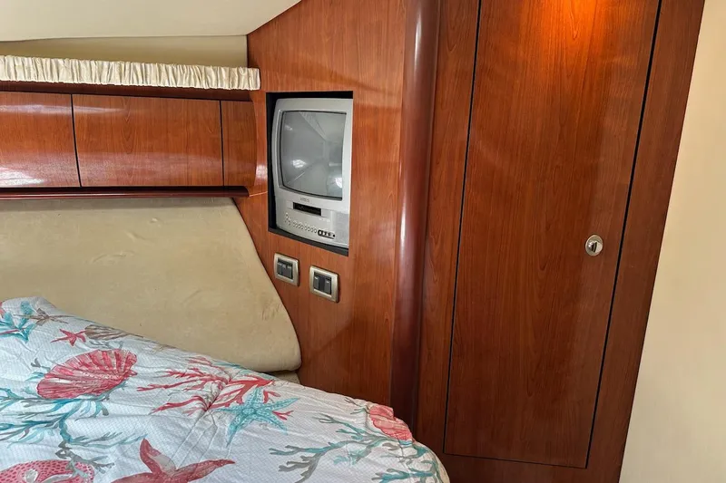 Slide: The Image of Interior of 2004 Sea Ray 420 Sundancer with wood paneling and built-in TV. - 19