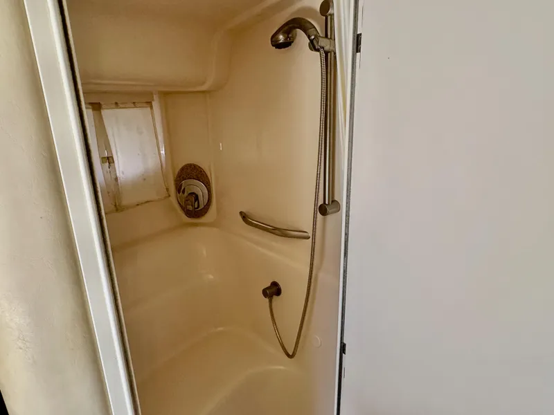Slide: The Image of Shower area in a 2004 Sea Ray 420 Sundancer yacht, featuring a handheld showerhead. - 21