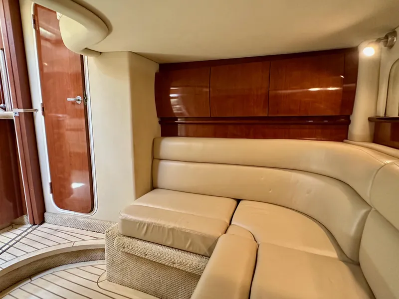 Slide: The Image of Luxurious interior of 2004 Sea Ray 420 Sundancer with beige seating and wooden accents. - 24