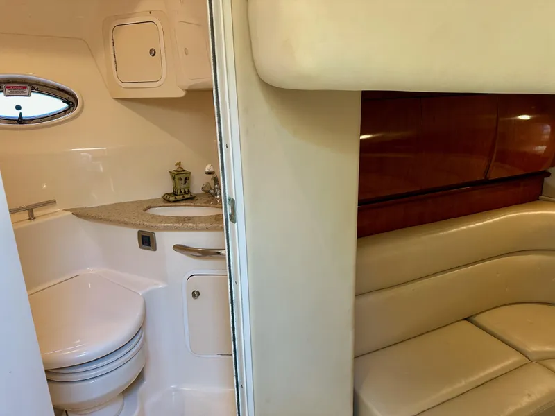 Slide: The Image of 2004 Sea Ray 420 Sundancer interior with bathroom and seating area. - 25