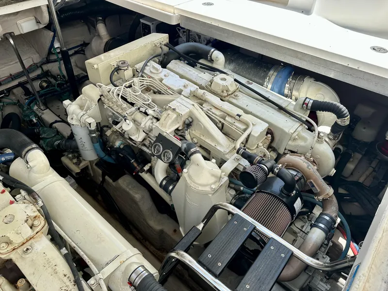 Slide: The Image of Engine compartment of a 2004 Sea Ray 420 Sundancer boat, showcasing mechanical components. - 27