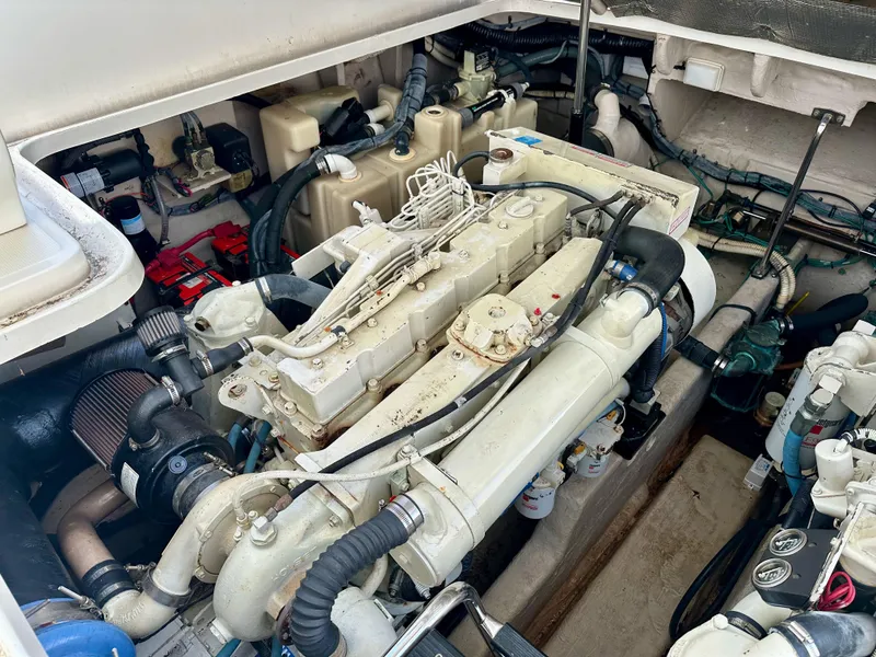 Slide: The Image of Engine compartment of a 2004 Sea Ray 420 Sundancer boat, showcasing mechanical components. - 28