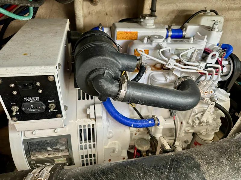 Slide: The Image of Engine compartment of a 2004 Sea Ray 420 Sundancer boat, featuring mechanical components. - 29