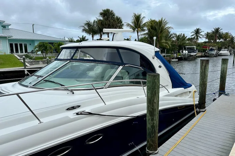 Slide: The Image of 2004 Sea Ray 420 Sundancer yacht docked by a canal with palm trees. - 32