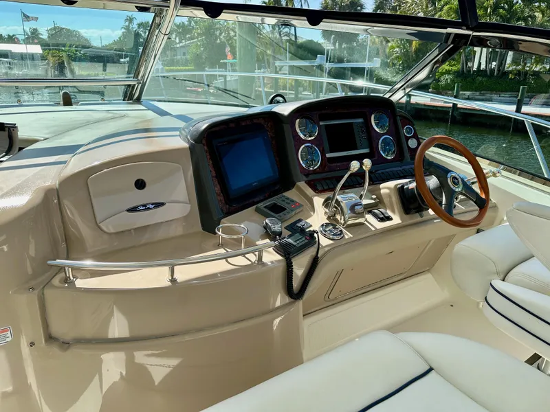 Slide: The Image of Helm of 2004 Sea Ray 420 Sundancer with modern controls and wood-accented steering wheel. - 6