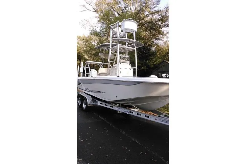 Slide: The Image of 2018 Carolina Skiff 21 Ultra Elite boat on trailer, parked outdoors. - 0