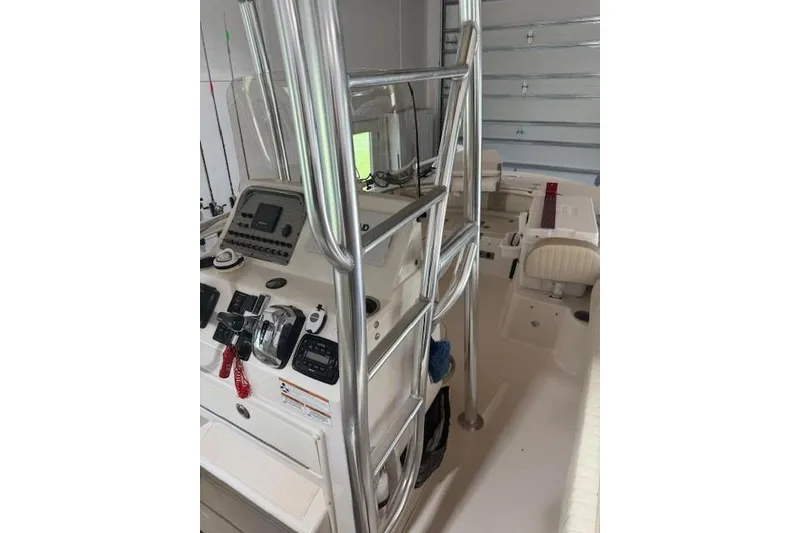 Slide: The Image of 2018 Carolina Skiff 21 Ultra Elite boat interior with control panel and seating. - 2