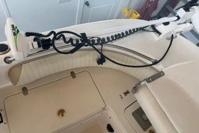 Slide: The Image of 2018 Carolina Skiff 21 Ultra Elite boat interior with trolling motor and storage compartments. - 7