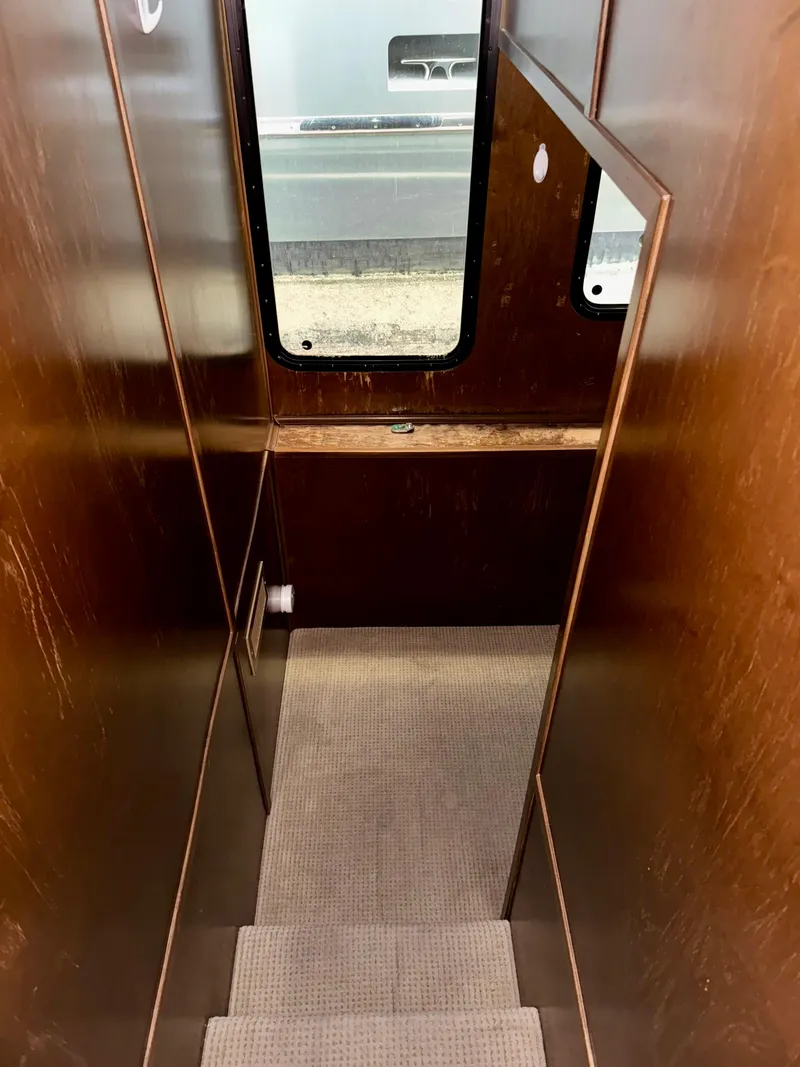 Slide: The Image of Narrow wooden staircase inside 2013 Bravada Bella Luna Share #8 with window view. - 11