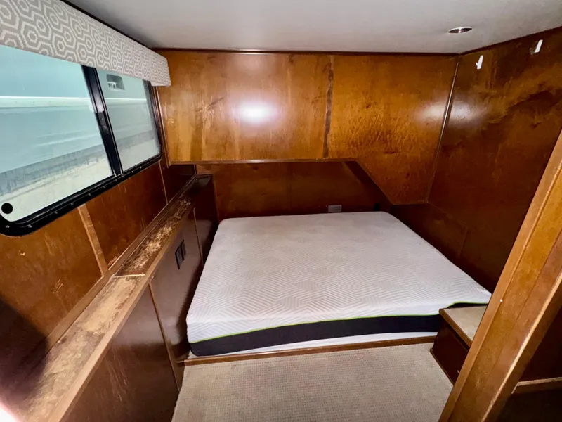 Slide: The Image of Bedroom interior of 2013 Bravada Bella Luna Share #8 with wooden walls and a mattress. - 12