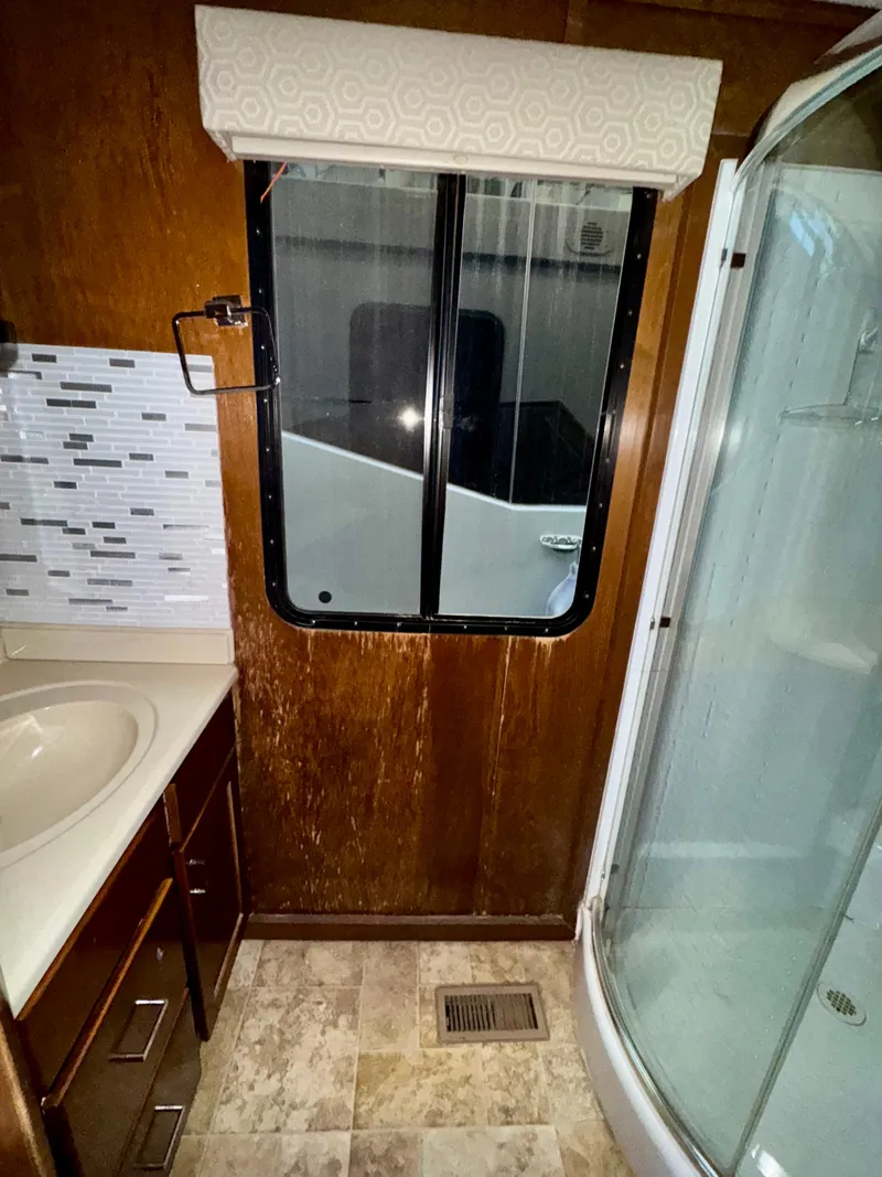 Slide: The Image of 2013 Bravada Bella Luna Share #8 bathroom with shower, sink, and window. - 16