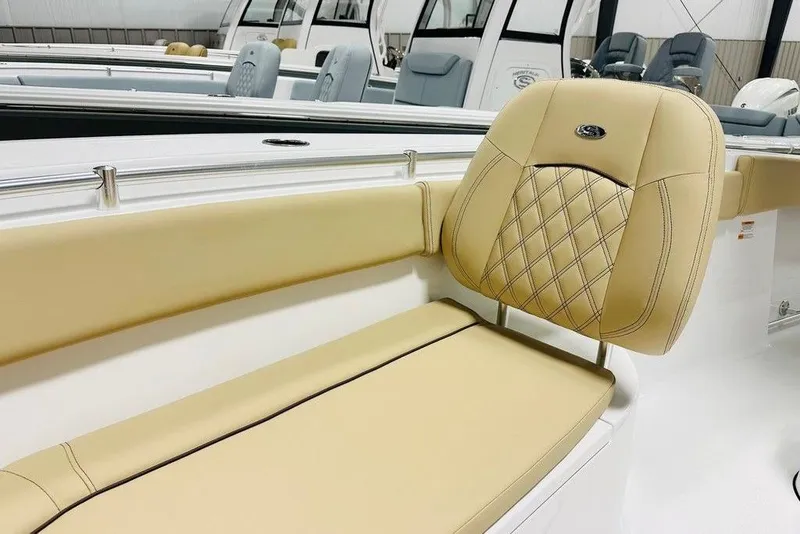 Slide: The Image of 2026 Sportsman Open 262 Center Console with tan cushioned seating detail. - 10