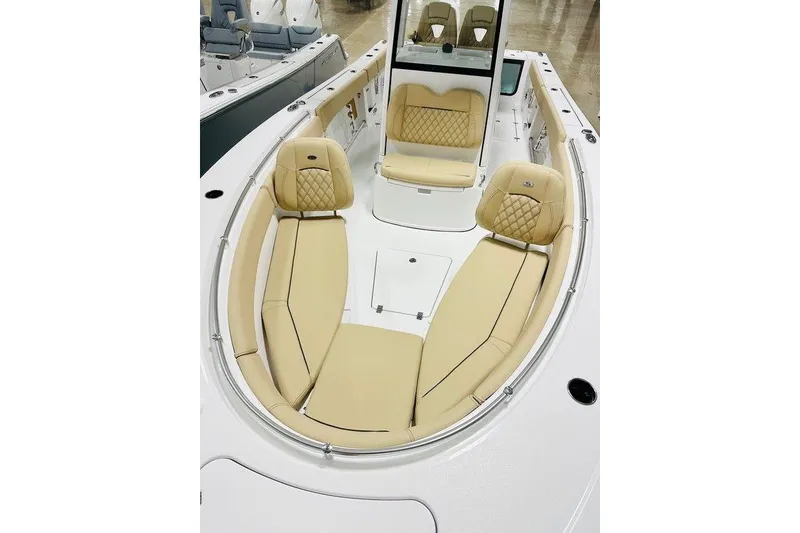 Slide: The Image of 2026 Sportsman Open 262 Center Console boat with luxurious tan seating. - 13