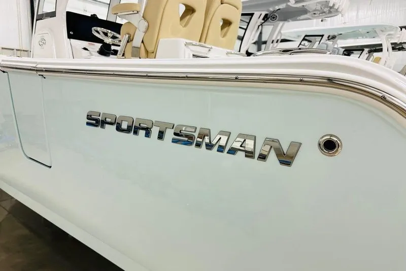 Slide: The Image of 2026 Sportsman Open 262 Center Console boat with sleek design and chrome logo. - 18