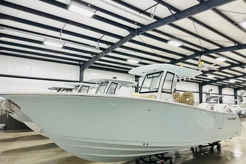 Slide: The Image of 2026 Sportsman Open 262 Center Console boat in a showroom, side view. - 21