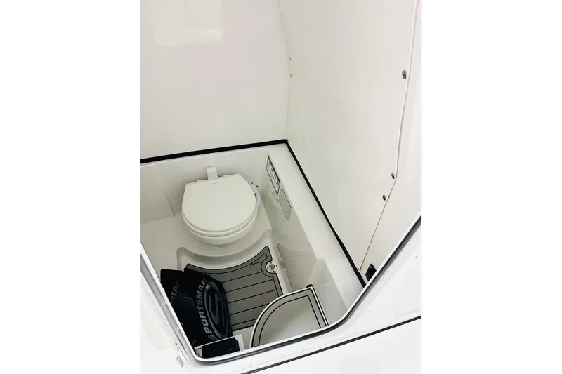 Slide: The Image of 2026 Sportsman Open 262 Center Console boat interior with toilet and storage area. - 4