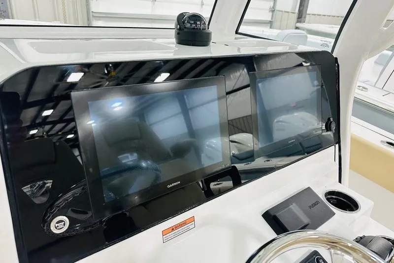 Slide: The Image of 2026 Sportsman Open 262 Center Console with dual Garmin displays and steering wheel. - 7