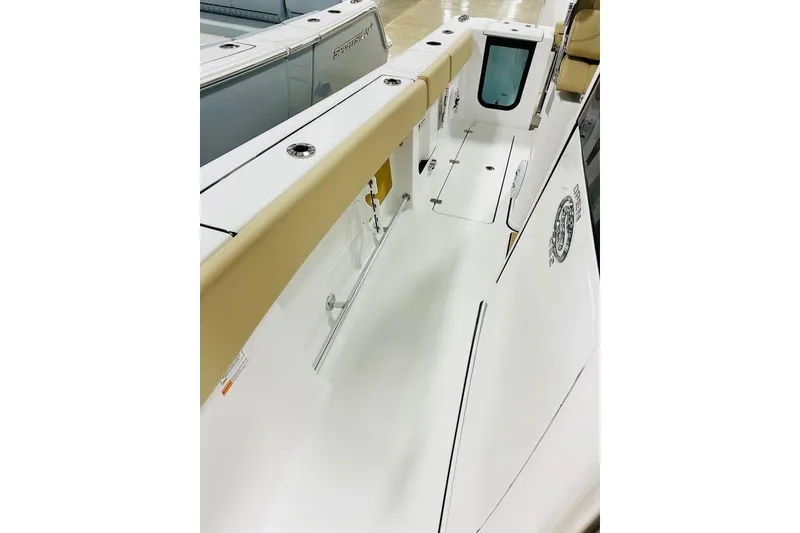 Slide: The Image of 2026 Sportsman Open 262 Center Console boat interior with beige seating and sleek design. - 9