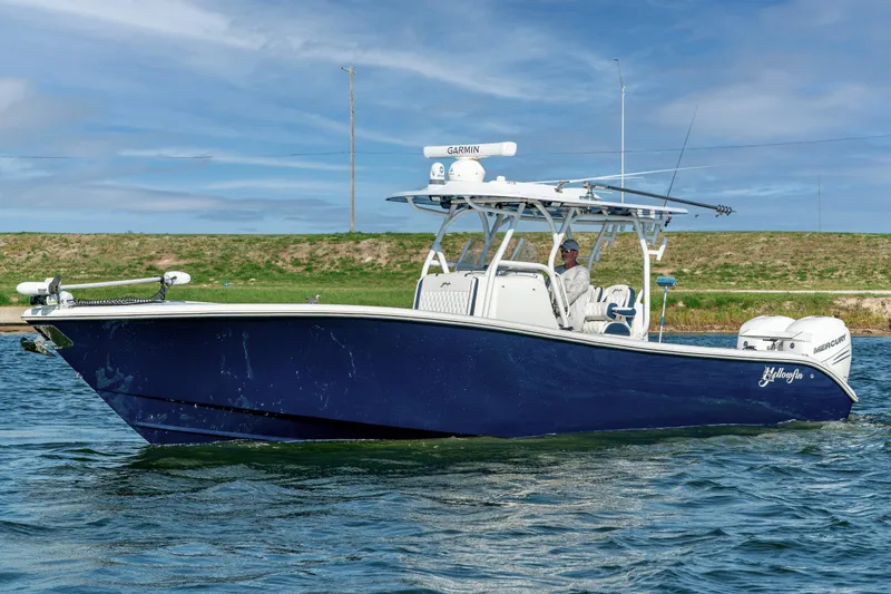 The Image of 2021 Yellowfin 32 Offshore boat on water, featuring sleek design and dual engines. - 0