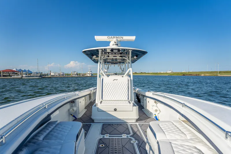 Slide: The Image of 2021 Yellowfin 32 Offshore boat on water, featuring sleek design and advanced navigation equipment. - 10