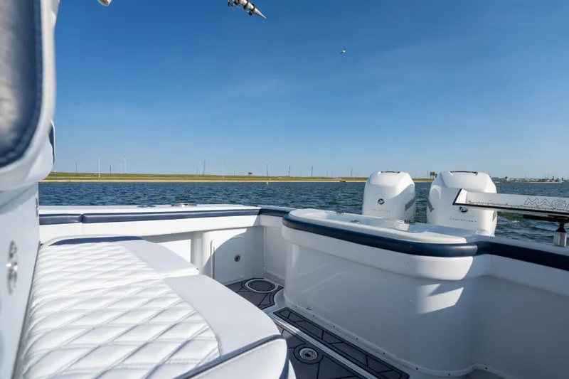 Slide: The Image of 2021 Yellowfin 32 Offshore boat with twin engines on calm water. - 11