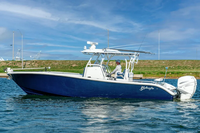 Slide: The Image of 2021 Yellowfin 32 Offshore boat on water, featuring sleek design and powerful engine. - 4