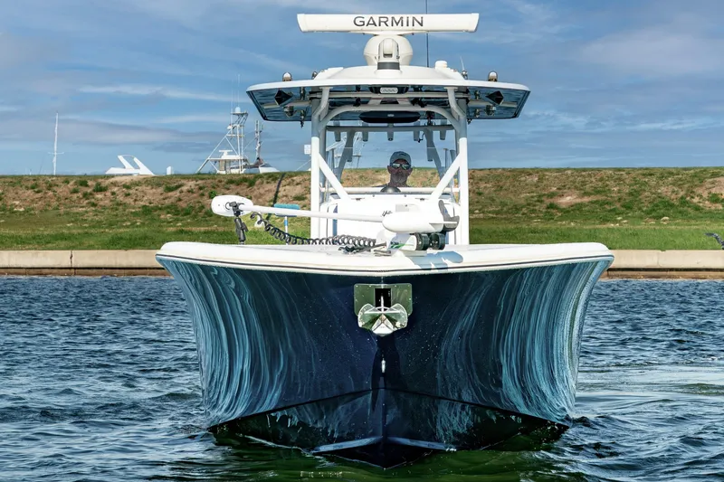 Slide: The Image of 2021 Yellowfin 32 Offshore boat on water, front view with Garmin equipment. - 5